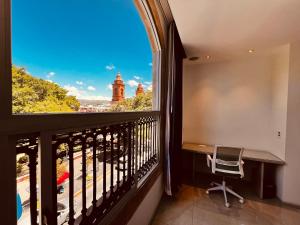 a balcony with a desk and a window at San Francisco Hotel Boutique in Huajuapan de León
