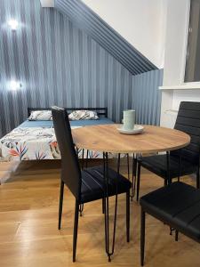 a dining room table with chairs and a bed at VIP hostel in Mukacheve