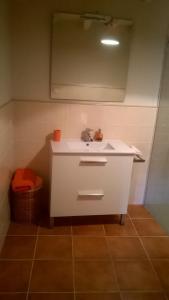 a bathroom with a white sink and a toilet at Ca La Marutxi in Cantallops