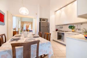 a kitchen and dining room with a table and chairs at La Villetta delle Stelle in Viareggio