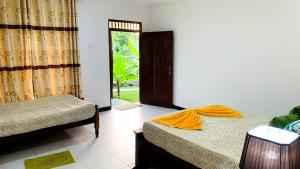 Letto o letti in una camera di Sigiri Prabha Villa