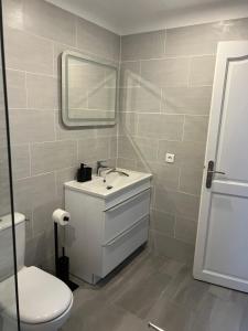 a bathroom with a sink and a toilet and a mirror at Résidence Lynda in Champigny-sur-Marne +22 photos