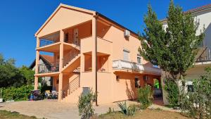a building with balconies on the side of it at Vila Vesna in Gornji Karin