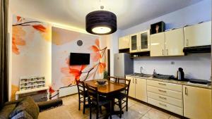 a kitchen with a table and a dining room at ŽUPAN apartmani in Soko Banja