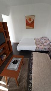 a room with a bed and a coffee table and a bed sidx sidx at Urban Retreat Dalmatinska in Podgorica