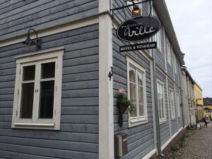 a blue building with a sign on the side of it at Pariisin Ville in Porvoo
