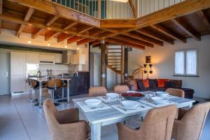a dining room and living room with a table and chairs at Villa 4 étoiles - 3 chambres - 6 personnes - Nature, campagne, confort moderne, charme, jardin et vue exceptionnelle - Proche Martel in Martel +13 photos
