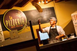a man standing behind a counter in a restaurant at Balmoral Hotel San José CR, Historic District in San José