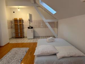 a bedroom with a bed with towels on it at Sparta- Minimalism in Kavadarci +15 photos