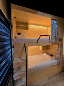 a bunk bed room with two bunk beds at Travelogue Guest House in Kuala Lumpur