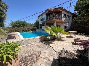 a villa with a swimming pool and a house at Country house Godall in La Galera