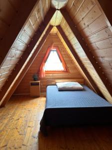 a bedroom with a bed in a attic at Bieszczady Pod Dębem Solina in Solina