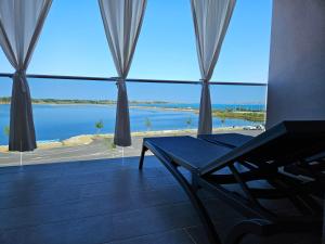 a room with a large window with a view of the water at APARTMAN SUNSIDE2 NIN in Nin
