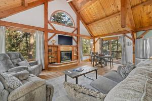 a living room with couches and a fireplace in a house at Whispering Pines Cabin in Rapid City