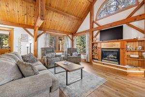a living room with a couch and a fireplace at Whispering Pines Cabin in Rapid City