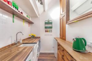 a kitchen with wooden counter tops and a sink at Alnwick Book Nook - dog friendly in Alnwick