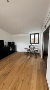 an empty room with a table and chairs in it at Maison Cosy - Maison de Maitre in Saint-André