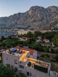 a view of a building with a mountain in the background at Marea DeLuxe Apartments in Kotor