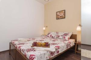a bedroom with a bed with two candles on it at Porta Aurea sunny studio in Pula
