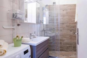 a bathroom with a sink and a shower at Porta Aurea sunny studio in Pula +7 photos
