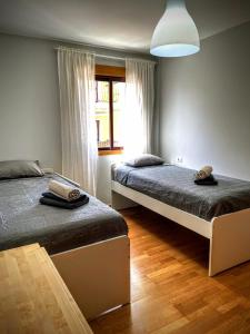 a bedroom with two beds and a window at La Pura Vida in Tazacorte +27 photos