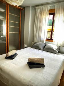 a bedroom with a bed with two towels on it at La Pura Vida in Tazacorte