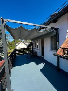 a patio with a canopy on the side of a building at Charming flat in Maribor
