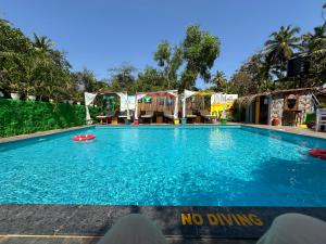 a swimming pool with a no diving sign on it at Art Resort Goa in Palolem