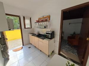 a small kitchen with a microwave on a counter at Brusque Comfort Studios in Brusque +28 photos