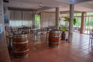 a room with tables and chairs and wooden barrels at Posada y Hosteria Sans Souci in Tanti