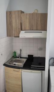 a kitchen with a sink and a stove at STUDIO Centre Ville in Aurillac