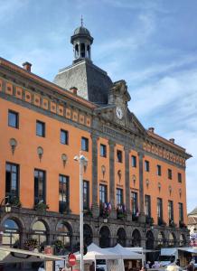 a large building with a clock tower on top of it at STUDIO Centre Ville in Aurillac