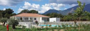 a house with a fence and a swimming pool at La BénéCIOLA, vue Mer, Box Fibre SFR, High Speed Internet in Cervione