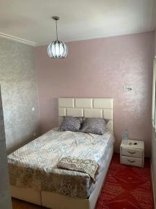 a bedroom with a bed and a lamp in it at Sérénité en bord de mer à Tamaris piscine, plage et bonheur in Dar Mohammed Ould Haj Jilali +7 photos