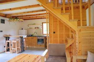 a kitchen and living room in a log cabin at Guest House Krsmanovic in Mokra Gora