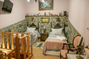 een slaapkamer met een bed en een stenen muur bij Casa Rural Salices in Pola de Laviana