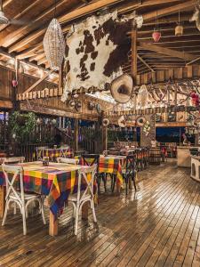 a restaurant with tables and chairs in a room at Finca las Isabeles in Xochitepec