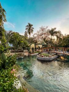 a swimming pool with a bridge in a resort at Finca las Isabeles in Xochitepec