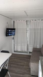 a living room with a couch and a window at La Campigna, Neuquen in Plottier +14 photos