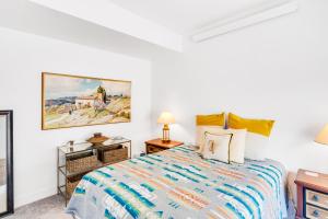 a bedroom with a bed and a painting on the wall at Sunlight Retreat in Steamboat Springs