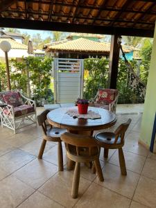 a wooden table and chairs on a patio at Casa de Praia - Long Beach - Cabo Frio - RJ in Tamoios