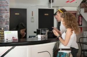 a man and a woman standing at a cash register at Be Ramblas Guest House in Barcelona