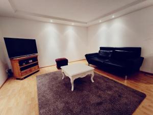 a living room with a couch and a coffee table at 3 Zimmer Wohnung EG in Bocholt