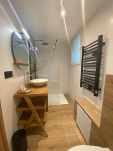 a bathroom with a sink and a mirror at Les Jardins de l'Oustal in Narbonne +46 photos