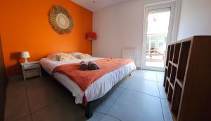 a bedroom with a bed with two shoes on it at Résidence Pasino in Lacanau-Océan