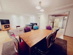 a dining room with a wooden table and chairs at Haus mit 6 Zimmer in Bocholt