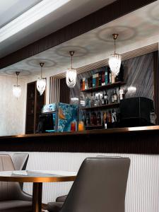 a bar in a restaurant with a table and chairs at Jasmine in Taraz