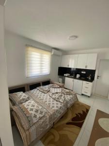 a small bedroom with a bed and a kitchen at Apartmani AMAN in Dobra Voda