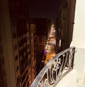 a view of a city street at night from a balcony at شقة فندقية vip برج رئيسي شارع الغشام مع موقف المنصورة in Manshīyat as Sādāt