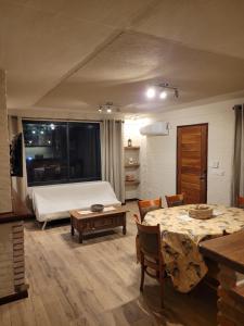 a room with a bed and a table and chairs at Casa en calle Mondello, Piriápolis in Piriápolis +6 photos